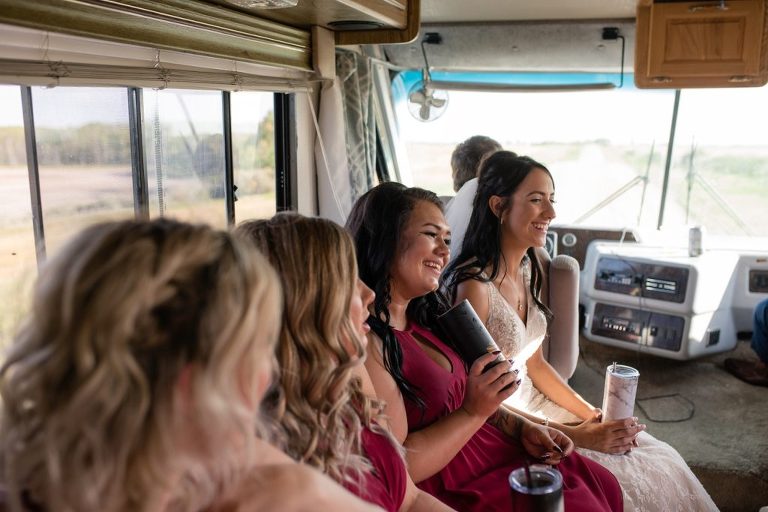 bride and bridesmaids laughing and smiling in an RV
