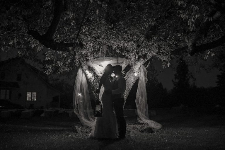 bride and groom portrait, night photography set up with string lights