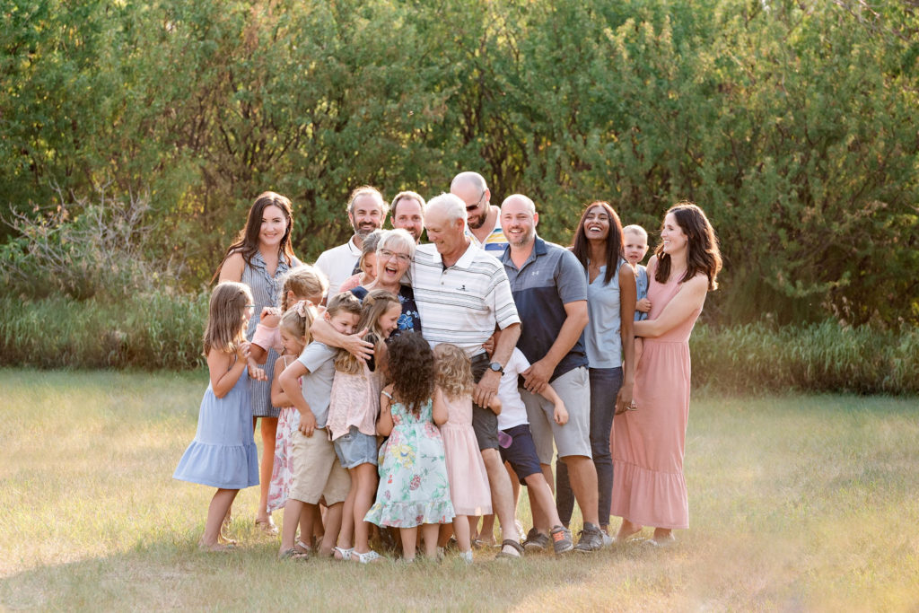 extended family big group hug