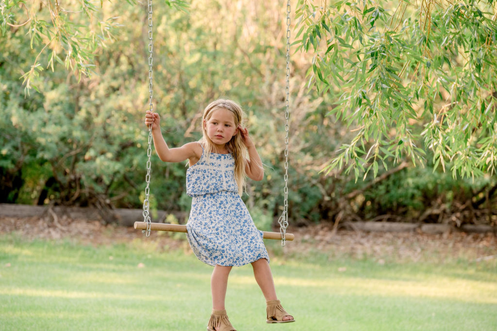 sitting on a tree swing
