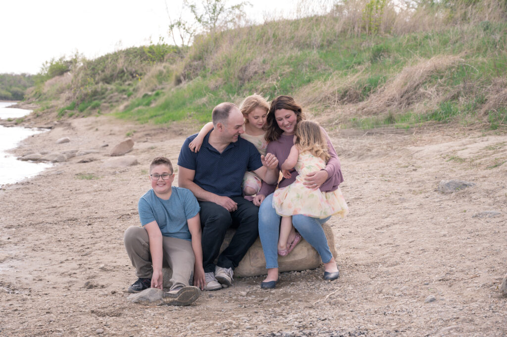 spring family photography session with young kids on the riverbank
